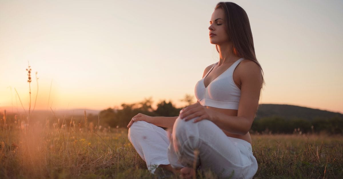 A young woman meditating outdoors