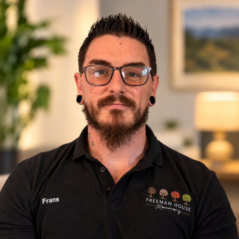 Frans Beetge | Recovery Assistant at Freeman House Recovery, pictured in a black polo shirt and glasses