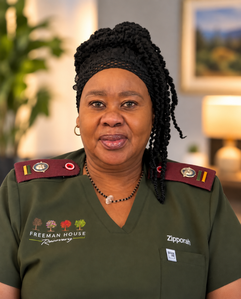 Sister Zipporah Gaven | Head of Nursing at Freeman House Recovery, pictured in a green nursing uniform